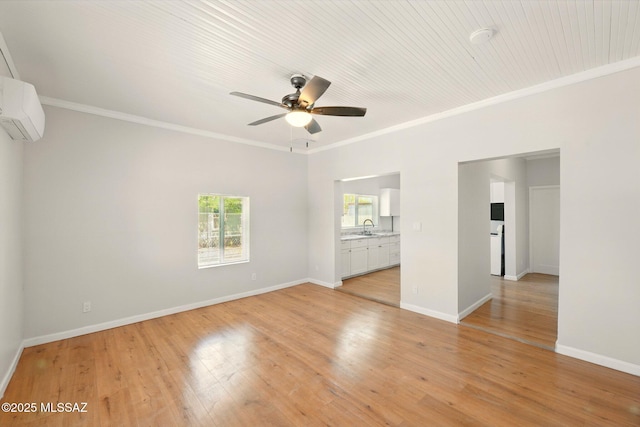 816 W 11th St, Safford, AZ 85546 - unfurnished room featuring a wall unit AC, a ceiling fan, ornamental molding, light wood-style floors, and a sink