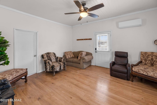 living room featuring ornamental molding, a wall mounted AC, ceiling fan, and light wood-type flooring