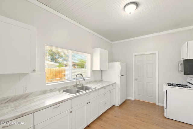816 W 11th St, Safford, AZ 85546 - kitchen with white appliances, a sink, white cabinets, light wood finished floors, and ornamental molding