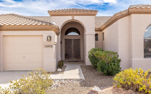 view of exterior entry with a garage