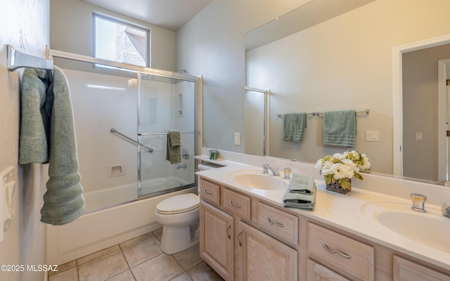 full bathroom featuring toilet, tile patterned flooring, vanity, and enclosed tub / shower combo