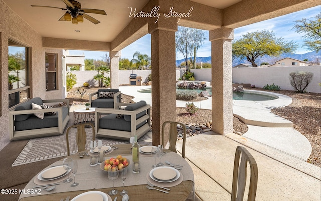 view of patio featuring an outdoor hangout area, ceiling fan, and a fenced in pool