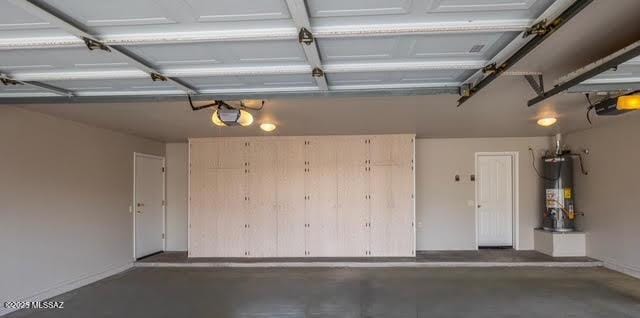 garage featuring a garage door opener and gas water heater