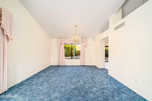 spare room featuring lofted ceiling, carpet floors, and an inviting chandelier