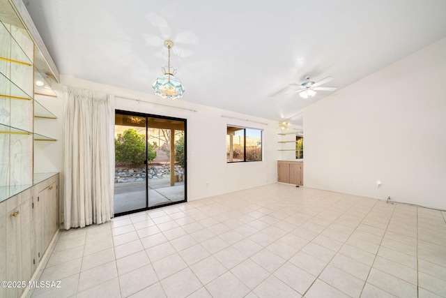 unfurnished room featuring vaulted ceiling, light tile patterned floors, and ceiling fan