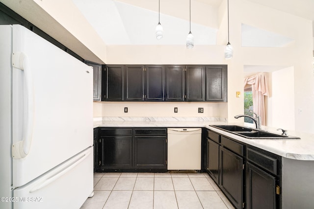 kitchen featuring decorative light fixtures, sink, light tile patterned floors, kitchen peninsula, and white appliances