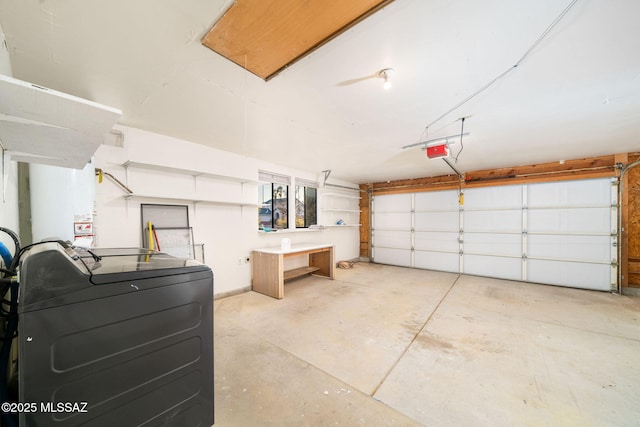 garage featuring a garage door opener and washer / dryer