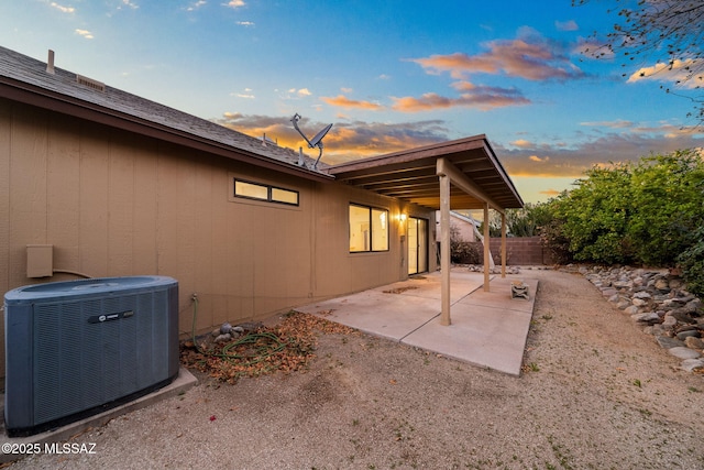 patio terrace at dusk featuring central air condition unit