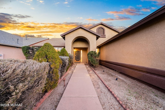 view of exterior entry at dusk