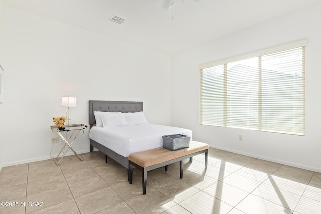 tiled bedroom with ceiling fan