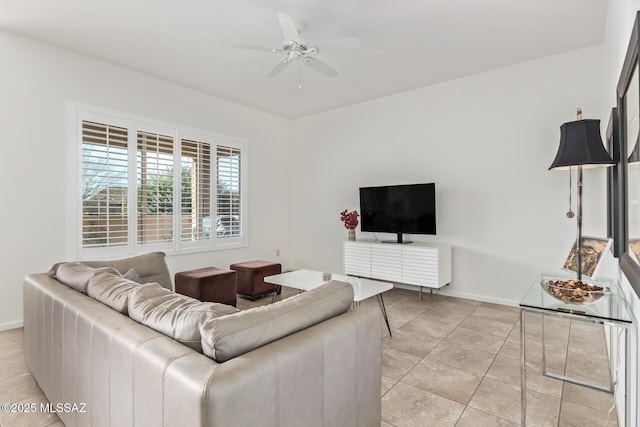 60437 E Arroyo Vista Dr, Oracle, AZ 85623 - living room with light tile patterned floors, a ceiling fan, and baseboards
