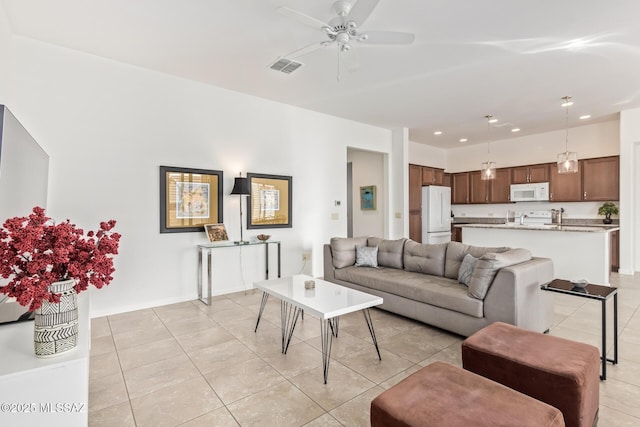 tiled living room featuring ceiling fan