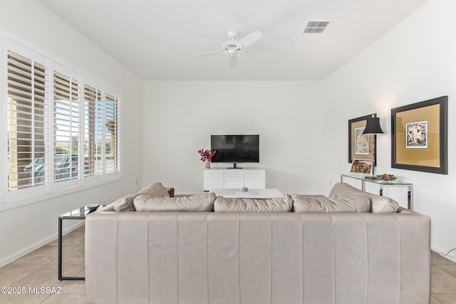 60437 E Arroyo Vista Dr, Oracle, AZ 85623 - living room with light tile patterned flooring, a ceiling fan, and baseboards