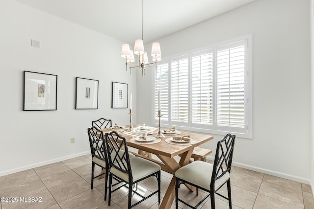 dining space with light tile patterned floors and an inviting chandelier