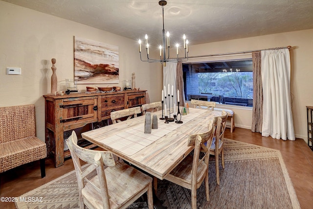 dining room featuring a notable chandelier and a textured ceiling