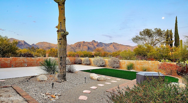 view of yard featuring a patio and a mountain view