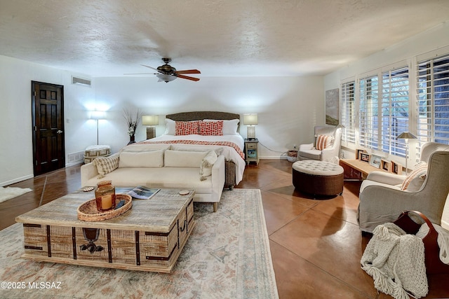 tiled bedroom with ceiling fan and a textured ceiling