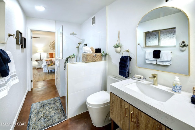 bathroom with hardwood / wood-style flooring, vanity, and toilet