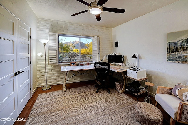 home office featuring dark hardwood / wood-style floors and ceiling fan