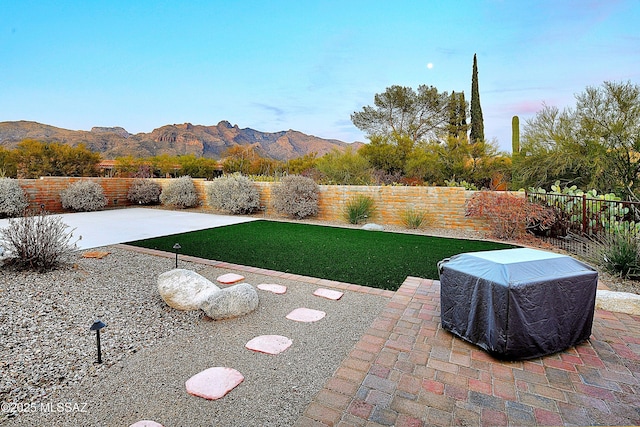 view of yard with a mountain view and a patio