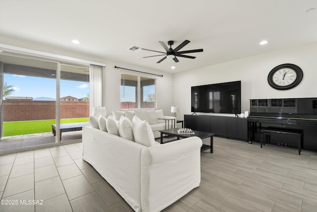 living area with visible vents, a ceiling fan, and recessed lighting