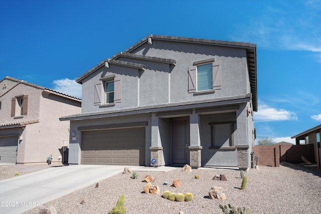 view of front of house featuring driveway, an attached garage, a tile roof, and stucco siding