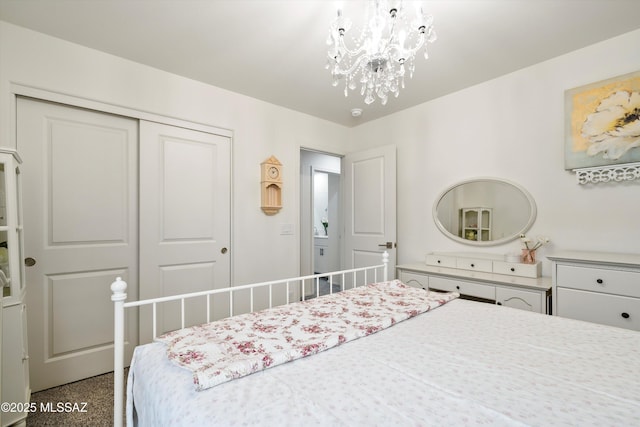 bedroom with a notable chandelier and a closet