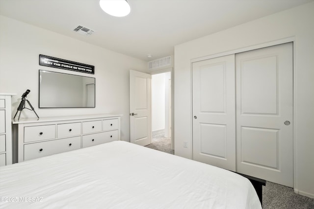 carpeted bedroom with a closet and visible vents