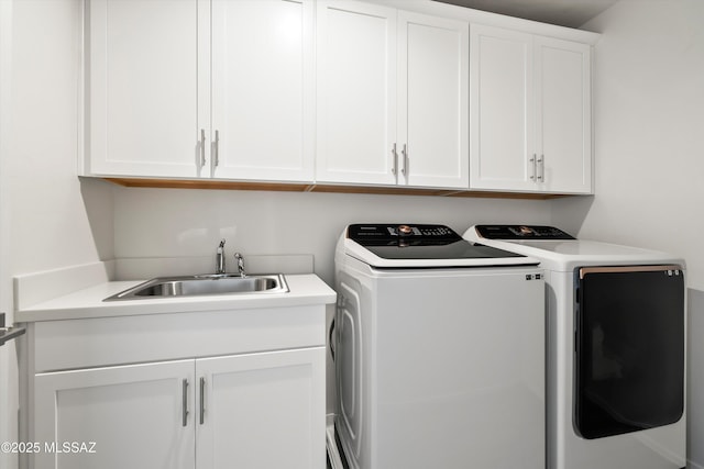 laundry area featuring cabinet space, washer and dryer, and a sink