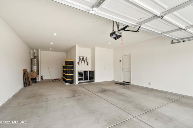 garage featuring a garage door opener, recessed lighting, and gas water heater