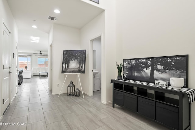 hallway with recessed lighting, visible vents, and baseboards