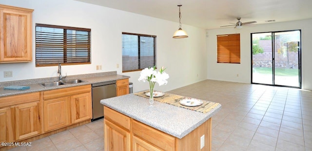 kitchen with a center island, sink, stainless steel dishwasher, light tile patterned floors, and pendant lighting