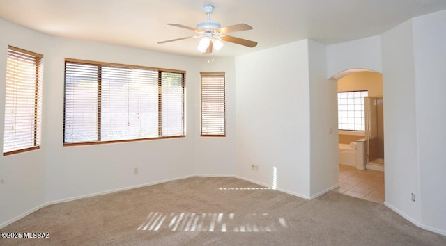 carpeted empty room featuring ceiling fan