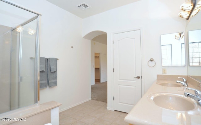 bathroom with tile patterned floors, vanity, and an enclosed shower