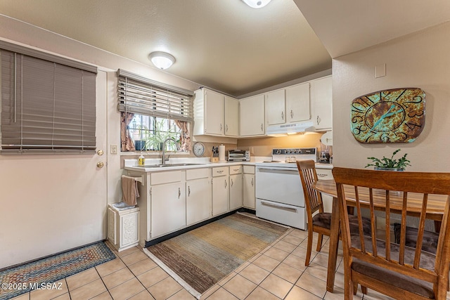 kitchen with white cabinetry, sink, light tile patterned floors, and electric stove