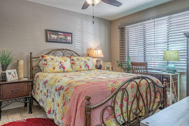 bedroom featuring ceiling fan and light tile patterned flooring