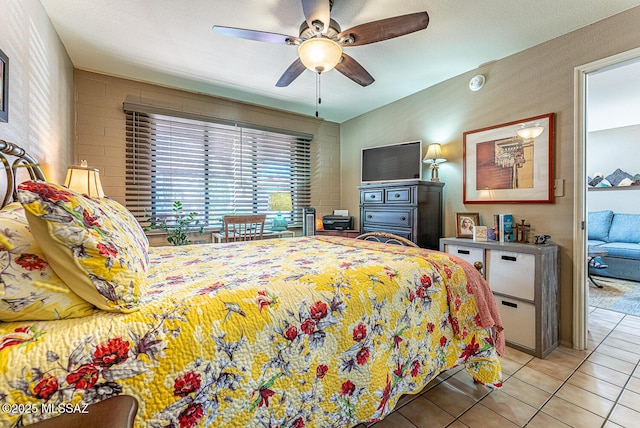 tiled bedroom with ceiling fan