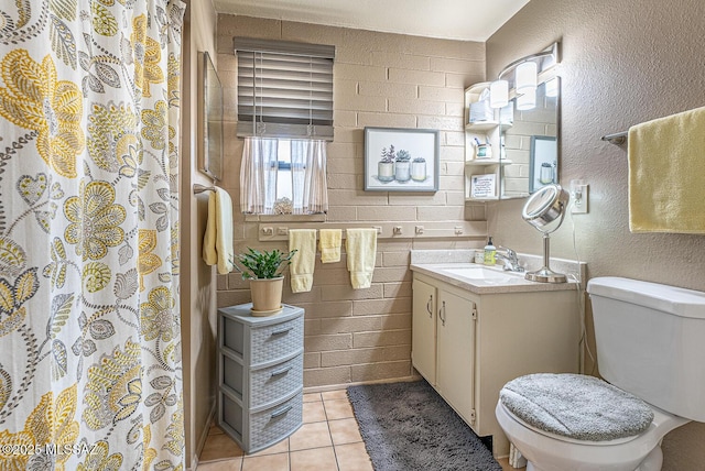 bathroom featuring vanity, tile patterned floors, and toilet