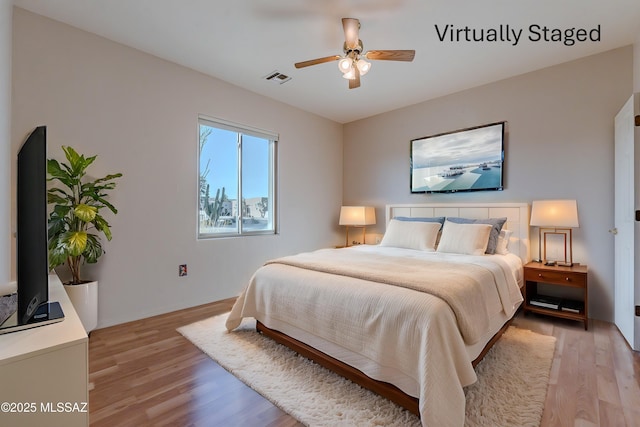 bedroom featuring visible vents, light wood-style flooring, and ceiling fan