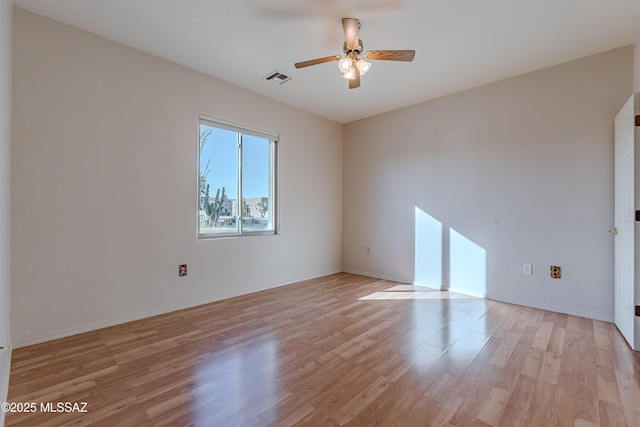 unfurnished room with visible vents, a ceiling fan, and light wood finished floors