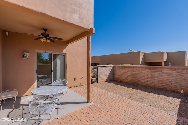 view of patio / terrace with fence and ceiling fan