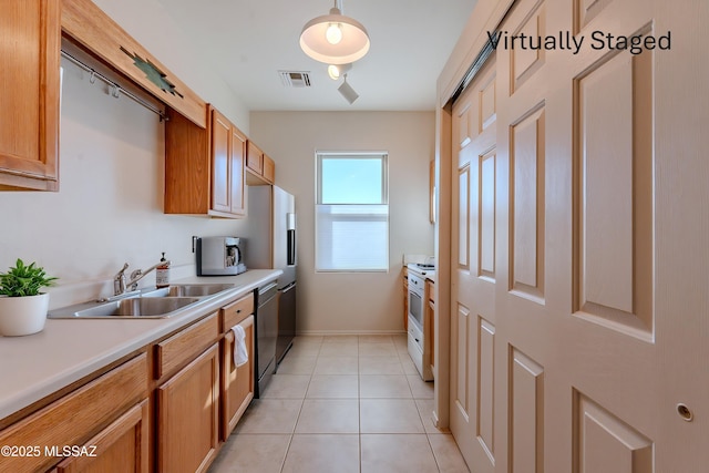 kitchen with light tile patterned floors, visible vents, white range with gas cooktop, a sink, and light countertops