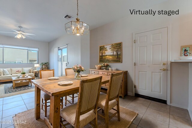 dining area featuring light tile patterned floors, visible vents, baseboards, and ceiling fan with notable chandelier