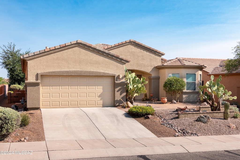 mediterranean / spanish-style home featuring a garage