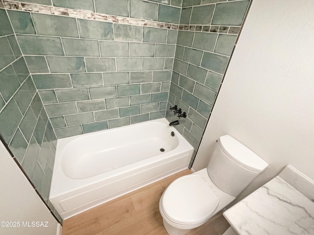 bathroom featuring tub / shower combination and toilet