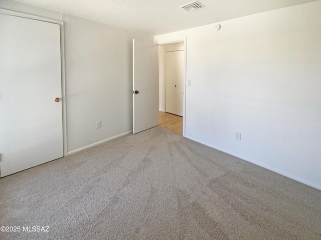 unfurnished bedroom with light colored carpet