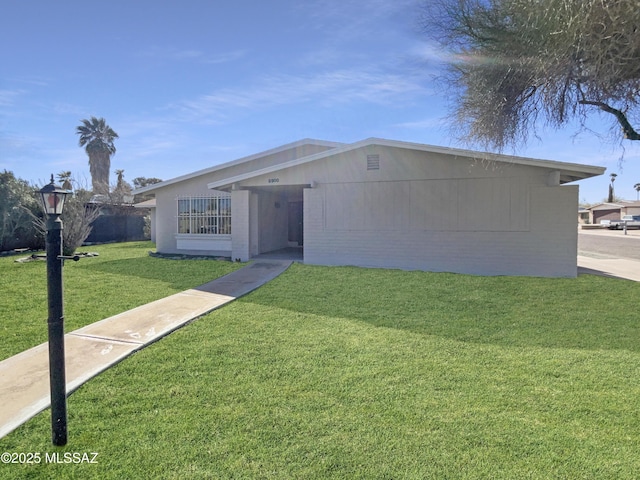 ranch-style home featuring a front yard