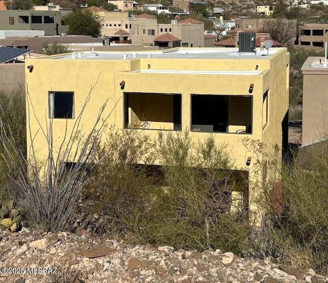 view of side of home featuring central AC