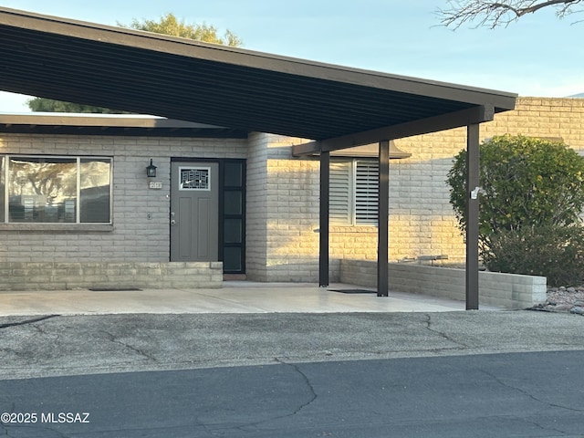 doorway to property featuring a carport