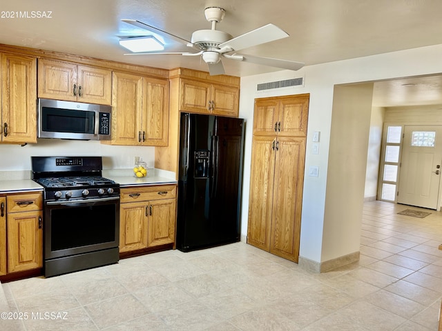 kitchen with stainless steel appliances, baseboards, visible vents, ceiling fan, and light countertops